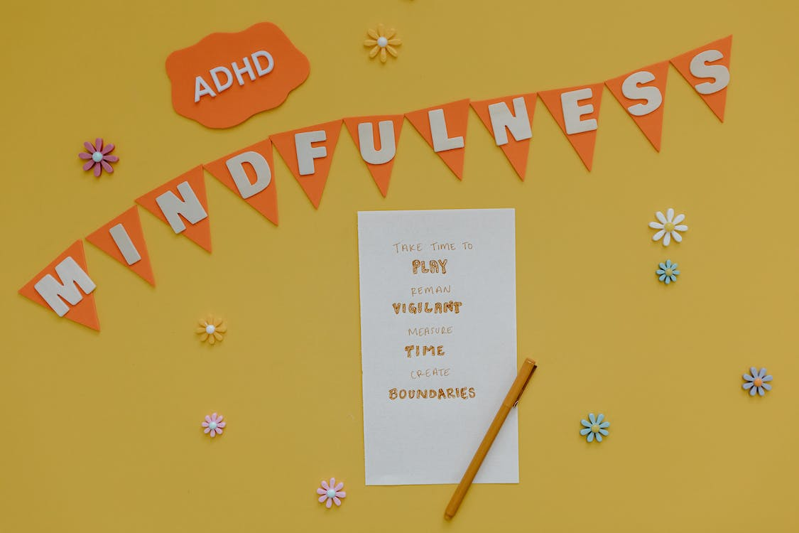 A banner saying “ADHD Mindfulness” and a paper with ADHD treatment advice