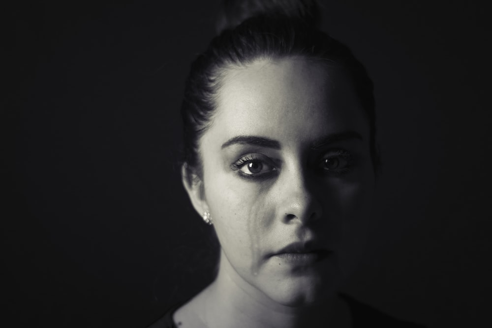 A woman crying before mental health counselling